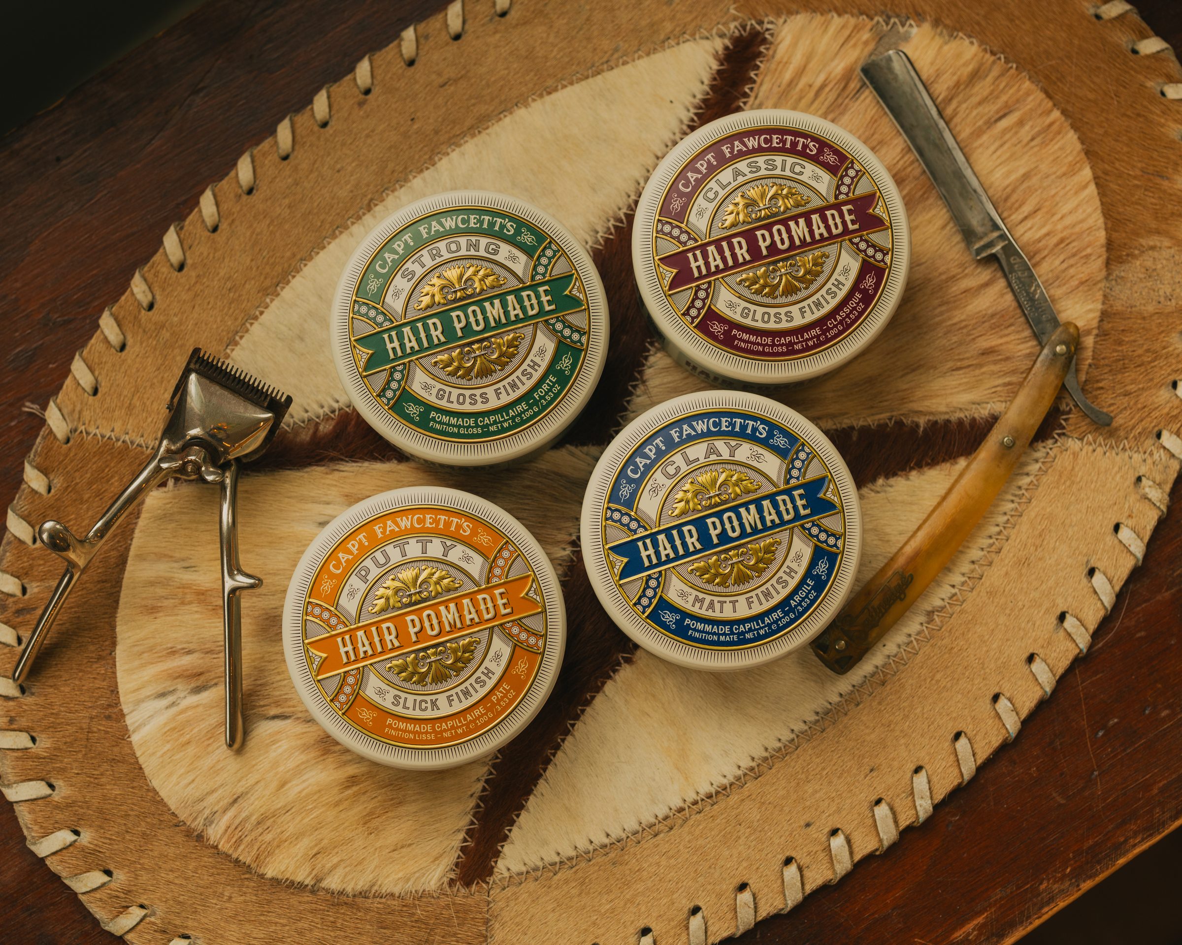 Captain Fawcett pomade range on cowhide leather with vintage barber tools